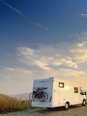an RV membership programs RV parked on a cliff overlooking a beautiful landscape